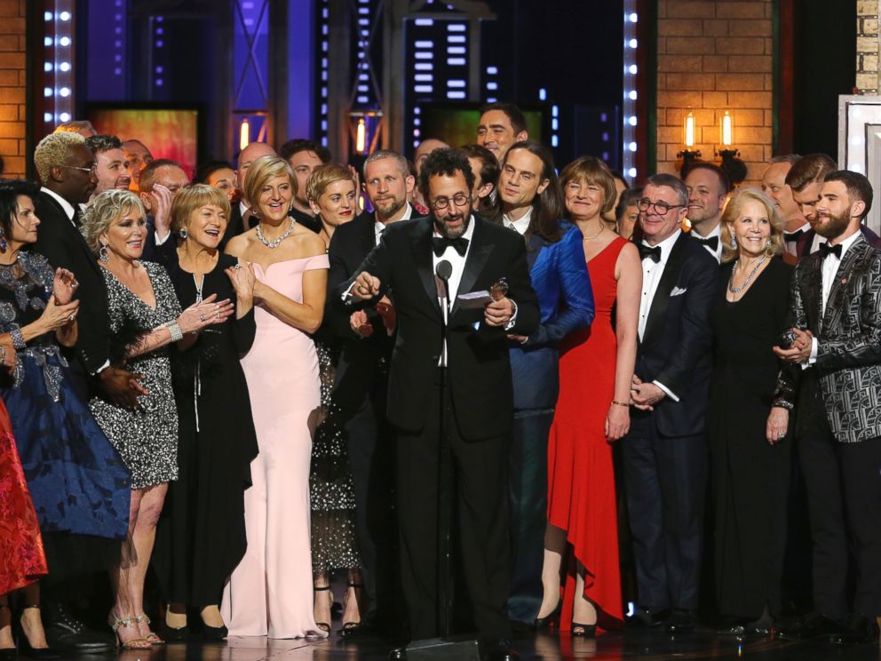 Playwright Tony Kushner, center, and the cast and crew of Angels in America accept the award for best revival of a play at the 72nd annual Tony Awards at Radio City Music Hall on Sunday, June 10, 2018, in New York.