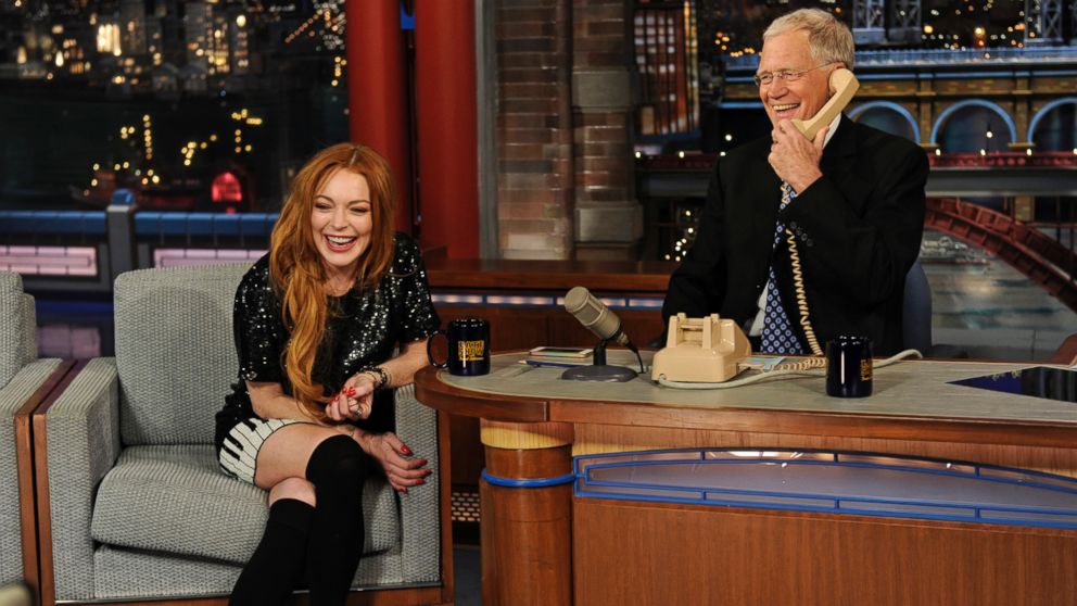 David Letterman and Lindsay Lohan give a call to their mutual friend Oprah Winfrey when Lohan visits The Late Show with David Letterman, April 9, 2014.