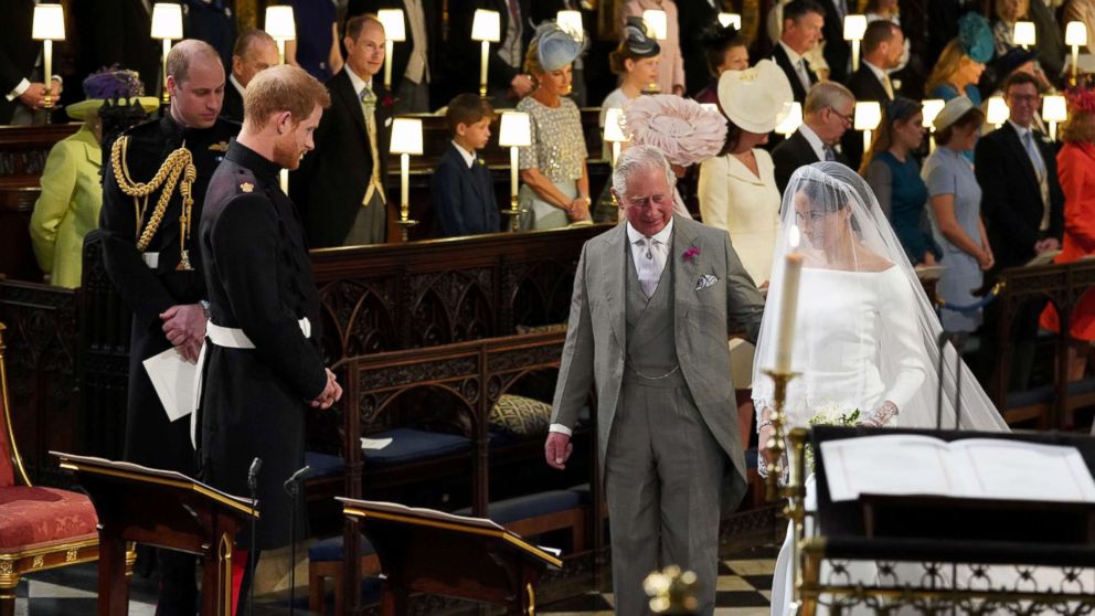 Prince Harry looks at his bride, Meghan Markle, as she arrives accompanied by the Prince of Wales in St George's Chapel at Windsor Castle for their wedding in Windsor, May 19, 2018.