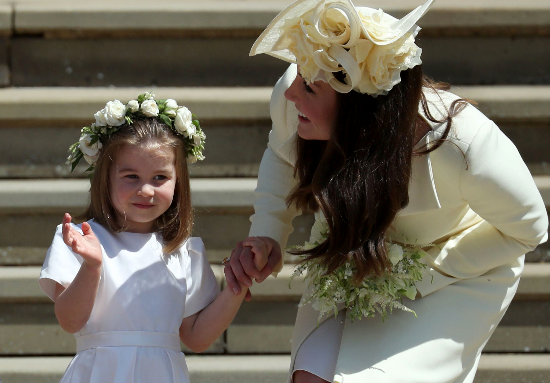 PHOTO: Princess Charlotte waves by her mother Britain's Catherine, Duchess of Cambridge after attending the wedding ceremony of Britain's Prince Harry and Meghan Markle at St George's Chapel in Windsor, May 19, 2018.