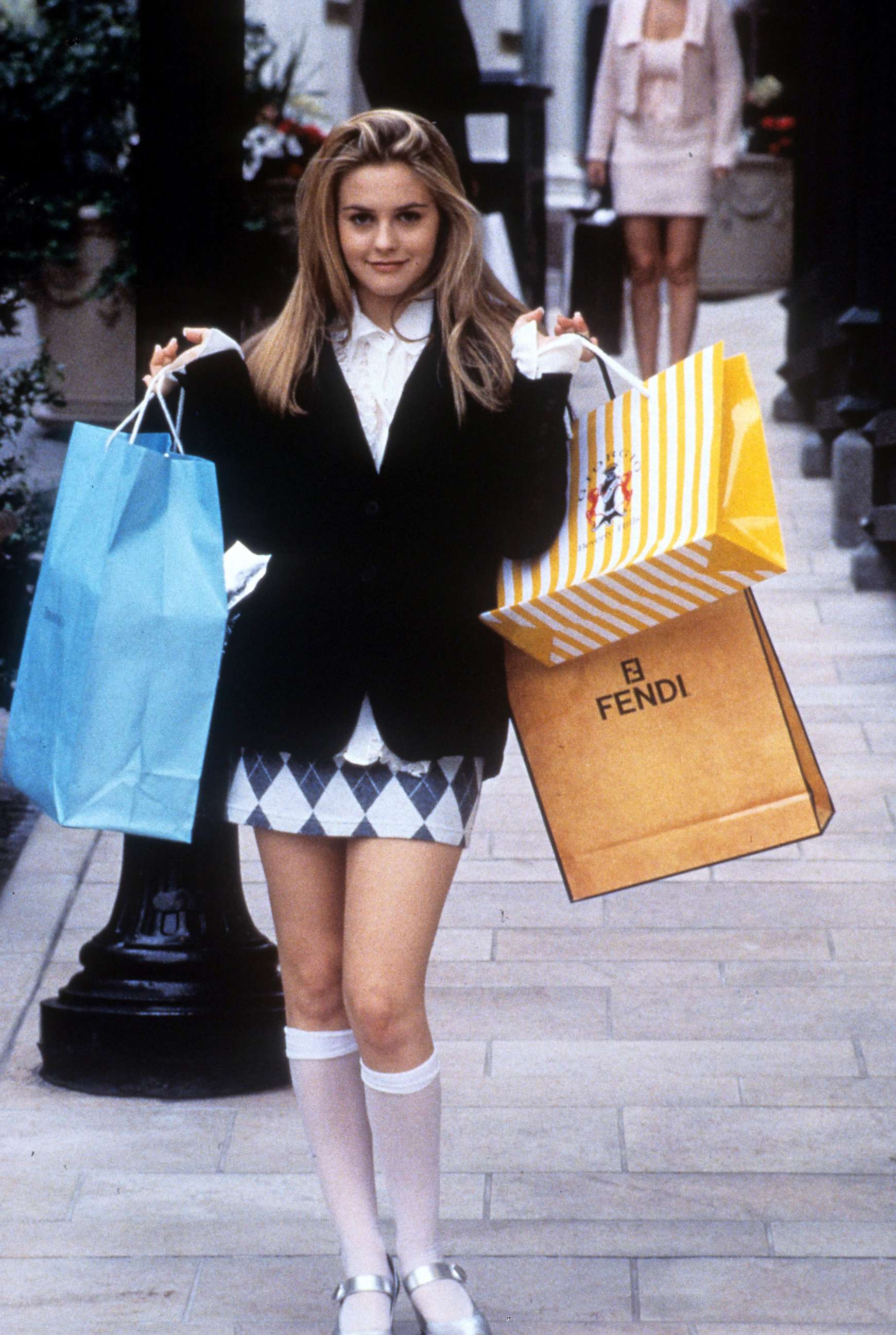 PHOTO: Alicia Silverstone holds shopping bags in a scene from the film "Clueless," 1995.