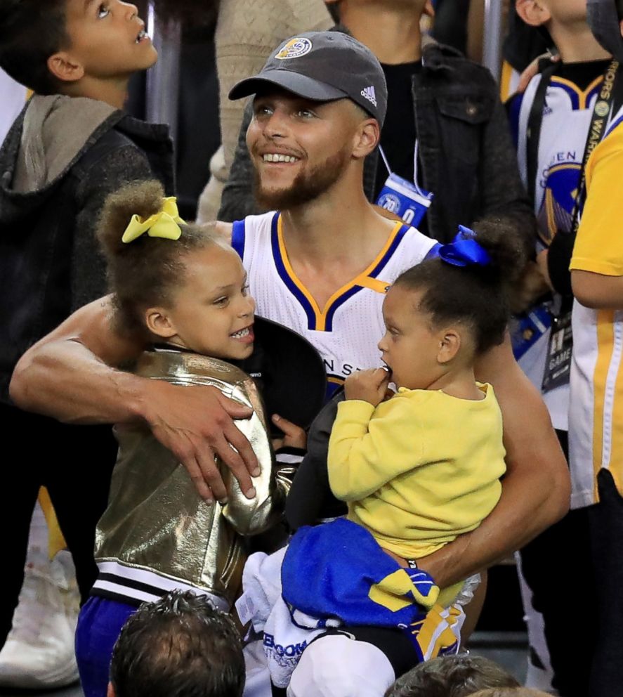 PHOTO: Stephen Curry of the Golden State Warriors celebrates holding his daughters Riley and Ryan after defeating the Cleveland Cavaliers 129-120 in Game 5 to win the 2017 NBA Finals at ORACLE Arena, June 12, 2017, in Oakland, Calif.