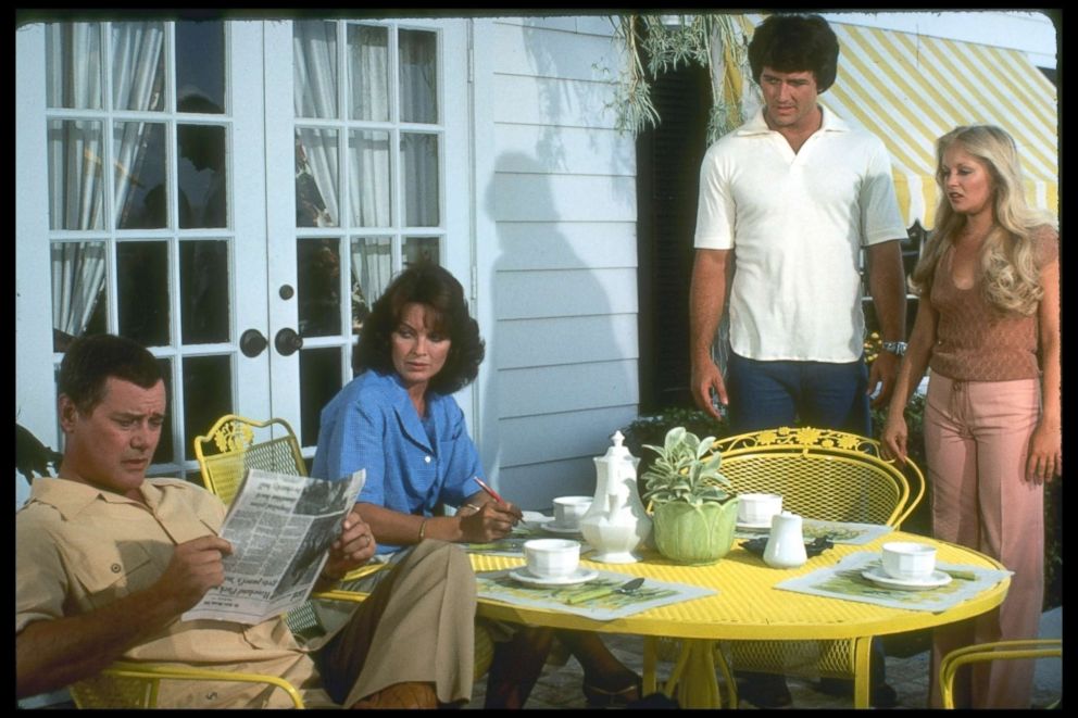 PHOTO: Larry Hagman (left) (as JR Ewing), Linda Gray (as Sue Ellen Ewing), Patrick Duffy (as Bobby Ewing), and Charlene Tilton (as Lucy Ewing) listen in an unidentified episode of the television series 'Dallas,' 1979. 