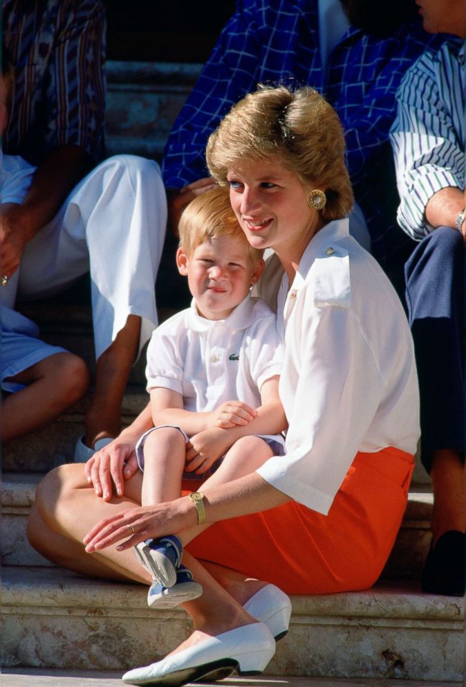 PHOTO: Diana, Princess Of Wales, sits on the steps of the Marivent Palace in Palma, Spain with Prince Harry on Aug. 13, 1988.