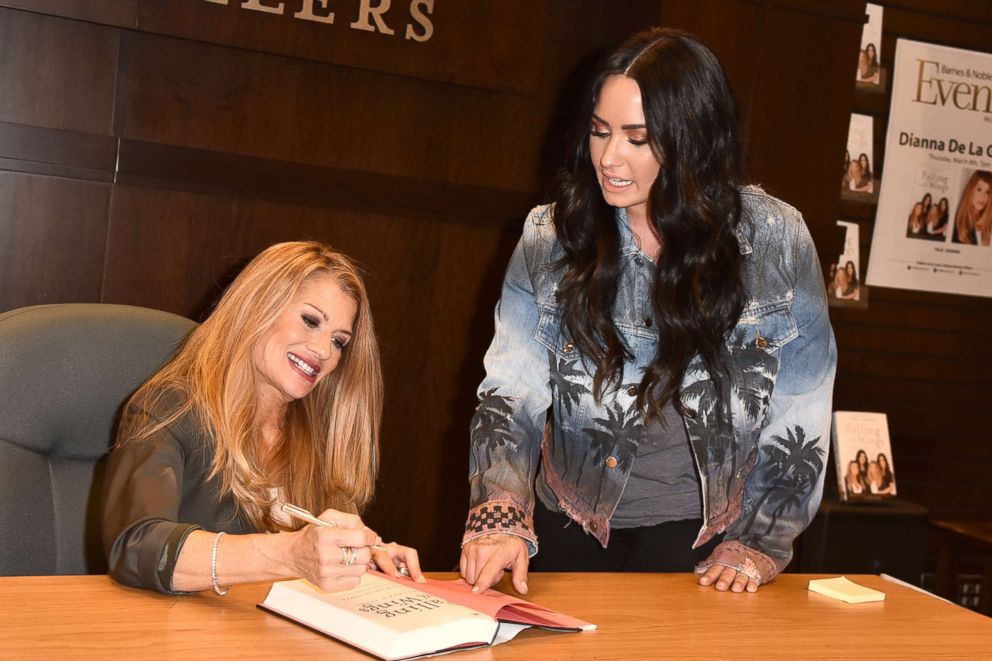 PHOTO: Dianna De La Garza (L) autographs her first novel to daughter Demi Lovato (R) during the book signing of her new book, "Falling with Wings" at Barnes & Noble at The Grove, March 8, 2018 in Los Angeles.
