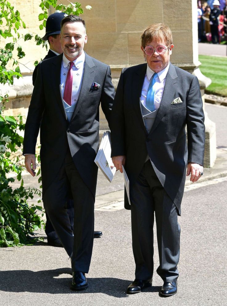 PHOTO: Sir Elton John (R) and husband David Furnish leave after attending the wedding ceremony of Prince Harry and Meghan Markle at St. George's Chapel, Windsor Castle in Windsor, England,May 19, 2018.
