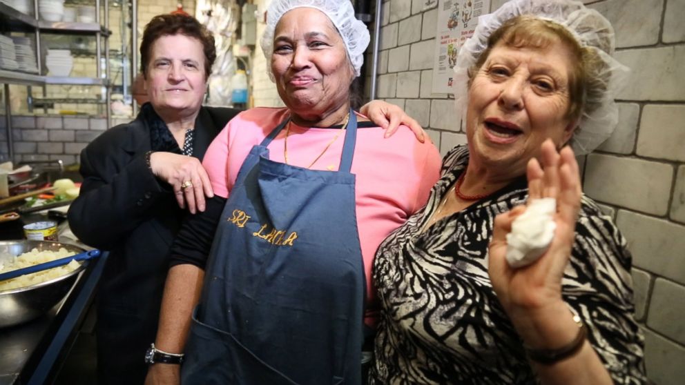 PHOTO: From left to right, Ploumitsa Zimnis, May "Dolly" Joseph and Maria Giannella, cook together in the kitchen of Enoteca Maria restaurant in New York City. 