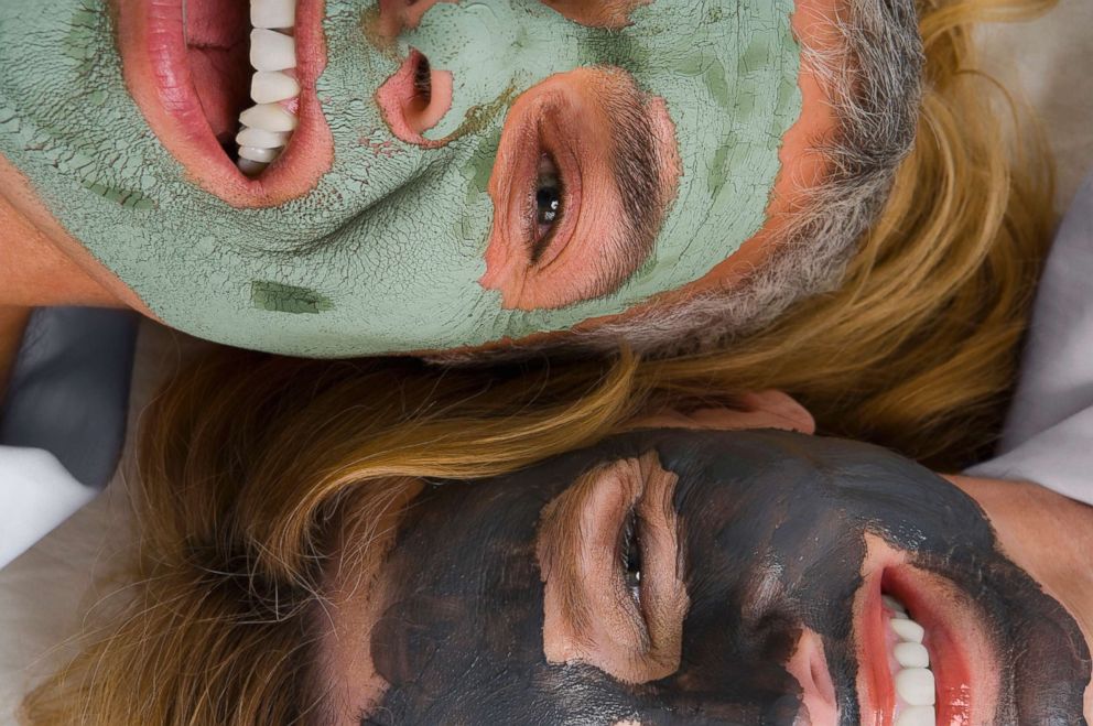 PHOTO: Two women are pictured smiling and wearing facial masks in this undated stock photo.