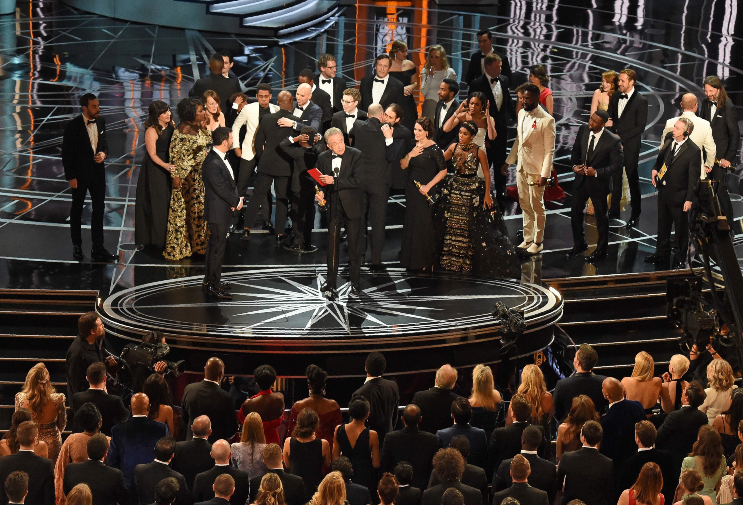 PHOTO: The cast of "Moonlight" and ""La La Land" appear on stage as presenter Warren Beatty shows the winner's envelope at the 89th Oscars on Feb. 26, 2017 in Hollywood, Calif.