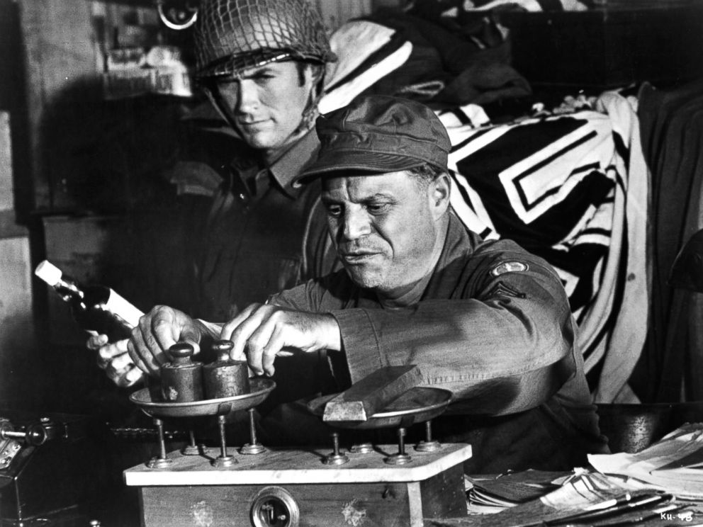 PHOTO: Clint Eastwood watches as Don Rickles weighs his captured ingots in a scene from the film 'Kelly's Heroes', 1970.