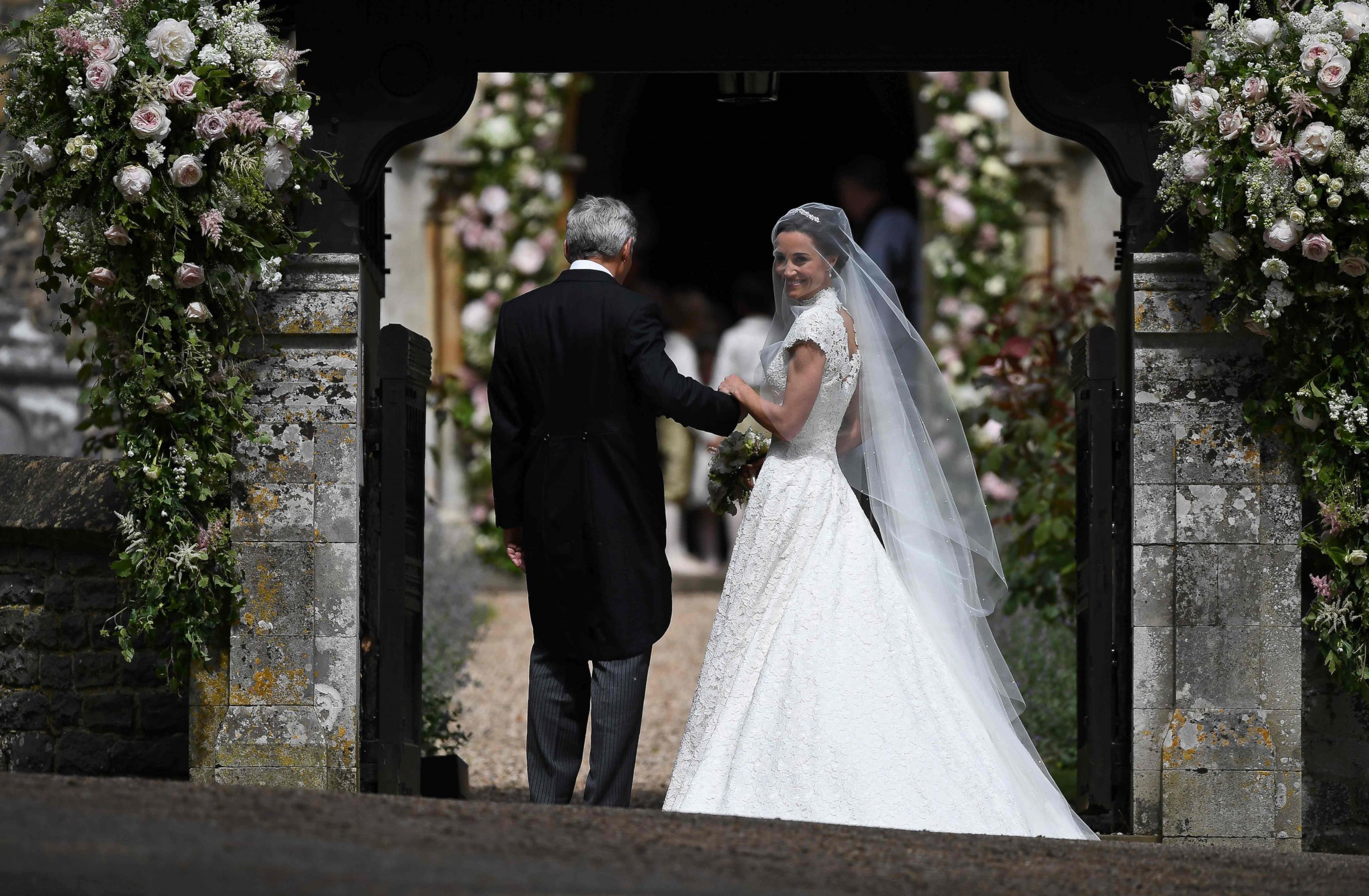 PHOTO: Pippa Middleton is escorted by her father Michael Middleton, as she arrives for her wedding to James Matthews at St Mark's Church in Englefield, west of London, May 20, 2017.