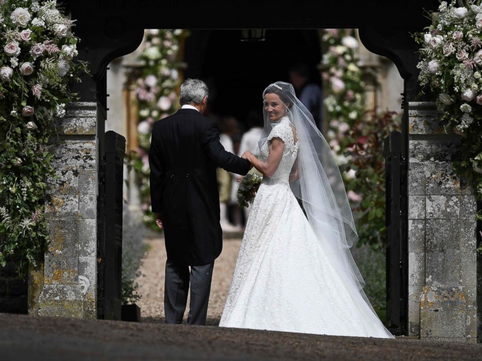 PHOTO: Pippa Middleton is escorted by her father Michael Middleton, as she arrives for her wedding to James Matthews at St Marks Church in Englefield, west of London, May 20, 2017.