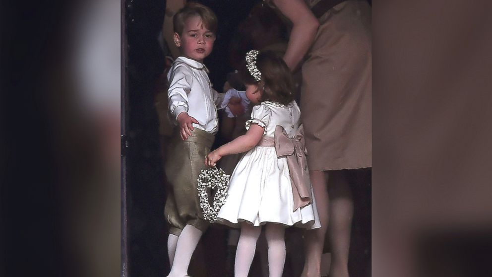 PHOTO: Britain's prince George, a pageboy, and princess Charlotte, a bridesmaid, stand with their nanny as they attend the wedding of their aunt Pippa Middleton to James Matthews at St Mark's Church in Englefield, west of London, May 20, 2017.