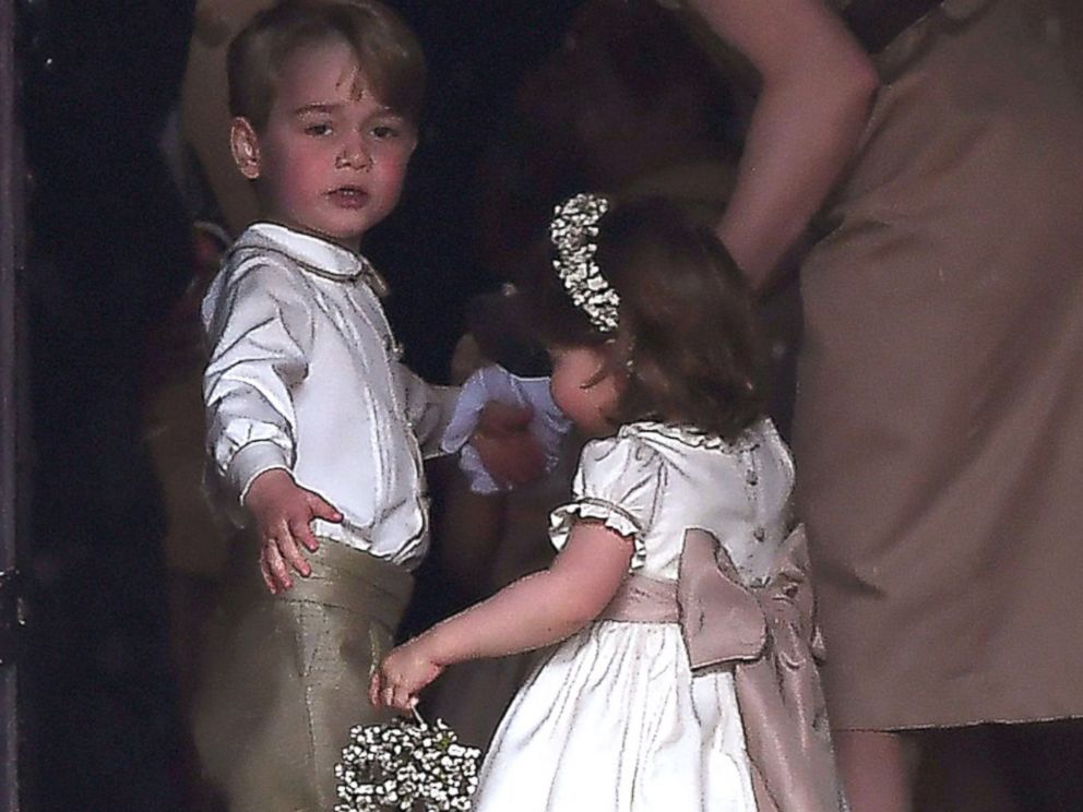 PHOTO: Britains prince George, a pageboy, and princess Charlotte, a bridesmaid, stand with their nanny as they attend the wedding of their aunt Pippa Middleton to James Matthews at St Marks Church in Englefield, west of London, May 20, 2017.