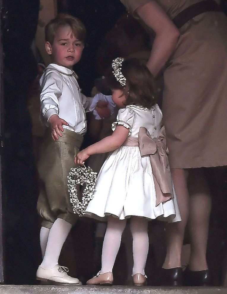 PHOTO: Britain's prince George, a pageboy, and princess Charlotte, a bridesmaid, stand with their nanny as they attend the wedding of their aunt Pippa Middleton to James Matthews at St Mark's Church in Englefield, west of London, May 20, 2017.