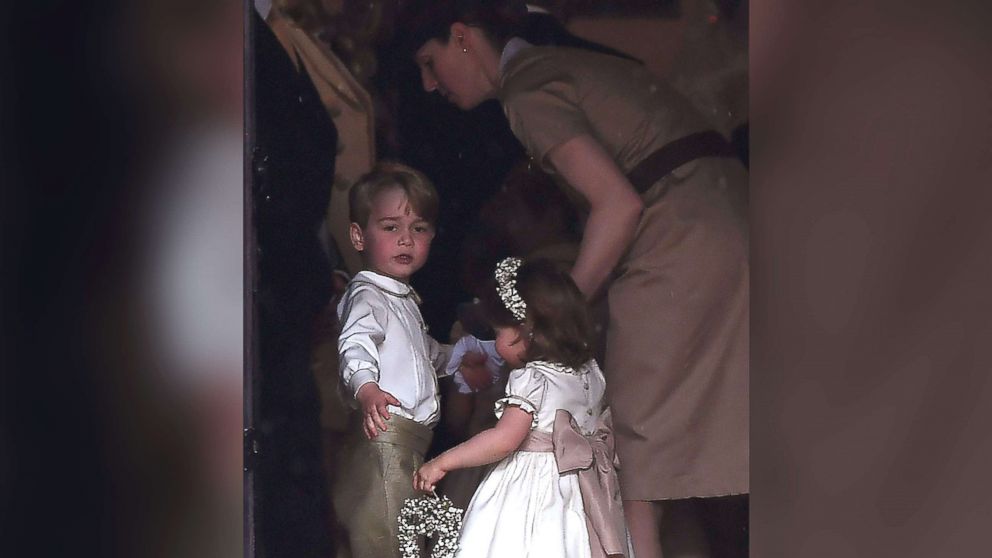 PHOTO: Britain's prince George, a pageboy, and princess Charlotte, a bridesmaid, stand with their nanny as they attend the wedding of their aunt Pippa Middleton to James Matthews at St Mark's Church in Englefield, west of London, May 20, 2017.