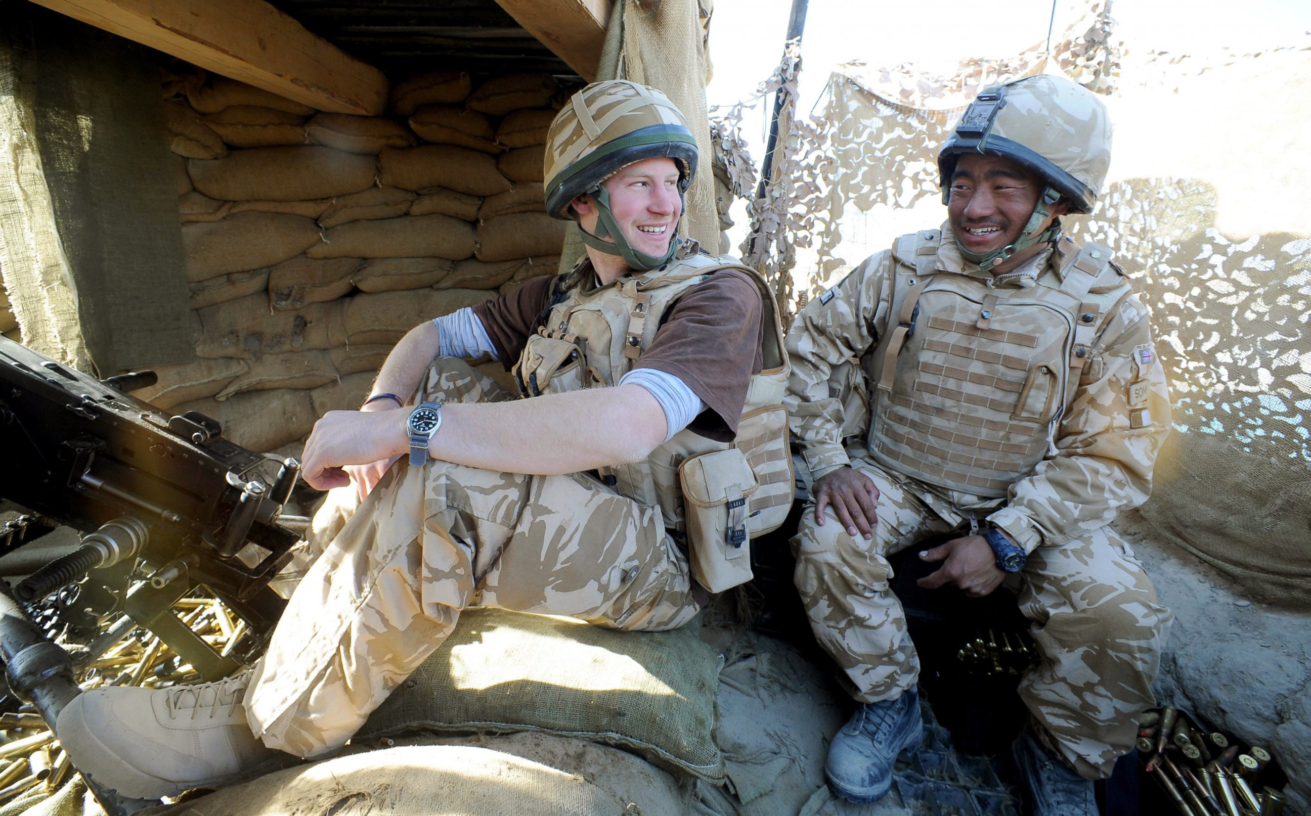 PHOTO: Prince Harry talks to a Gurkha soldier after firing a 50mm machine gun at Taliban fighters from the observation post in Helmand province, Southern Afghanistan, Jan. 2, 2008.