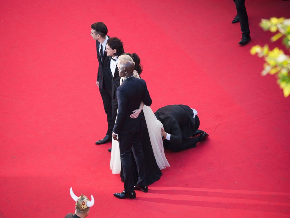 PHOTO: A man invades the Red Carpet as Jay Baruchel, Kit Harington, America Ferrera, Cate Blanchett and Djimon Hounsou pose at the How To Train Your Dragon 2 premiere during the 67th Annual Cannes Film Festival on May 16, 2014 in Cannes, France.