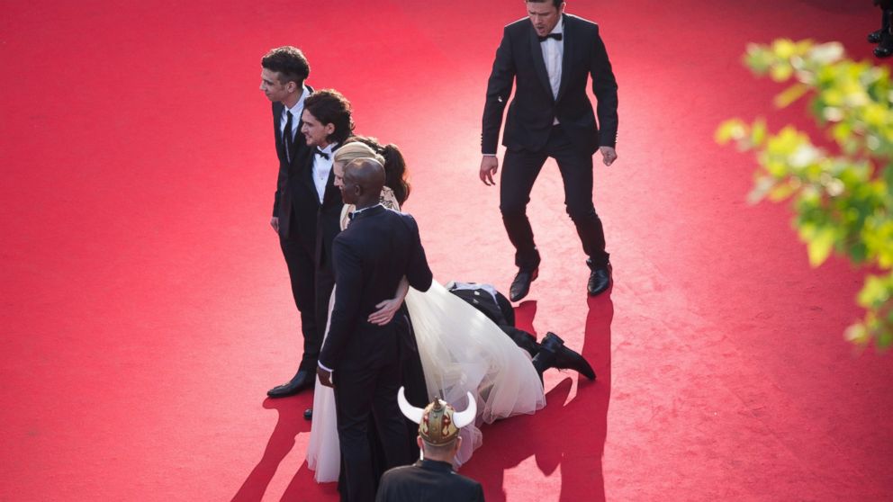 PHOTO: A man invades the Red Carpet as Jay Baruchel, Kit Harington, America Ferrera, Cate Blanchett and Djimon Hounsou pose at the 'How To Train Your Dragon 2' premiere during the Cannes Film Festival on May 16, 2014 in Cannes, France. 