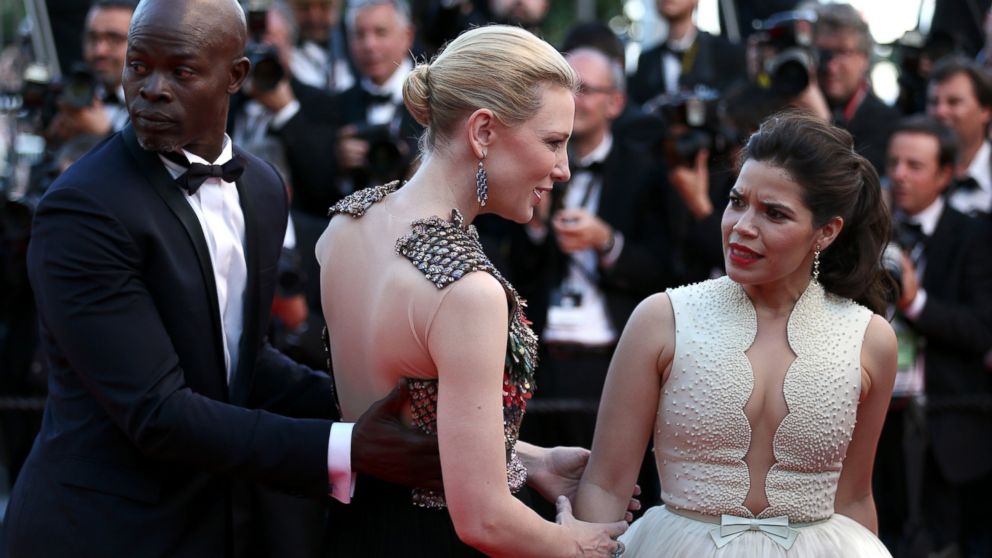 America Ferrera reacts after a man attempted to climb under her dress on the red carpet at the "How To Train Your Dragon 2" premiere during the Cannes Film Festival on May 16, 2014 in Cannes, France.