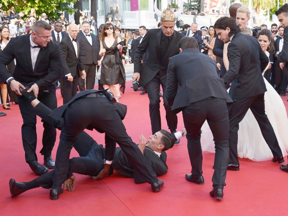 PHOTO: A man is held by security after invading the read carpet at the How To Train Your Dragon 2 premiere during the 67th Annual Cannes Film Festival on May 16, 2014 in Cannes, France.