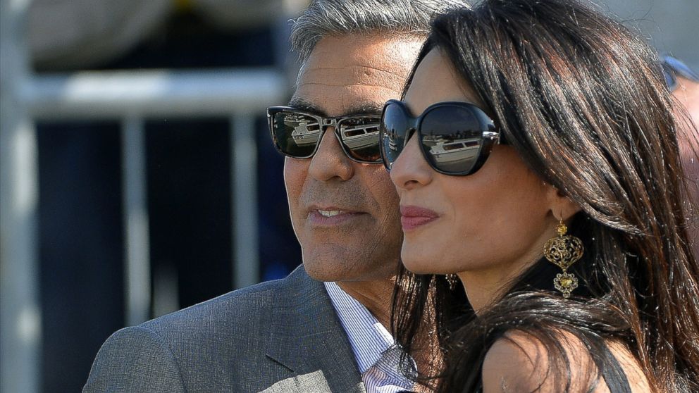 George Clooney ( L) and Amal Alamuddin, his Lebanon-born British fiancee, on a taxiboat in Venice upon their arrival on Sept. 26, 2014. 