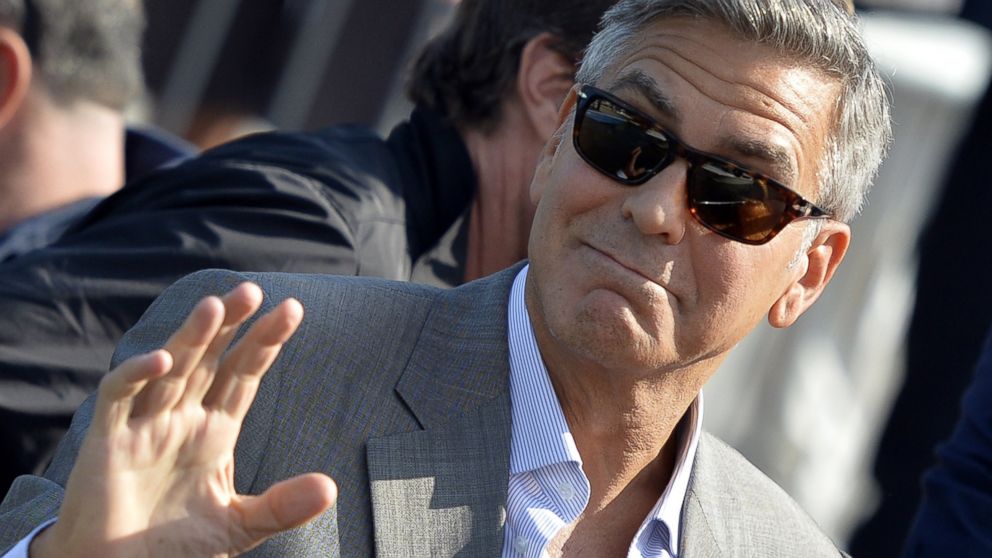 PHOTO: George Clooney waves from a taxiboat in Venice on Sept. 26, 2014 on the eve of his wedding.