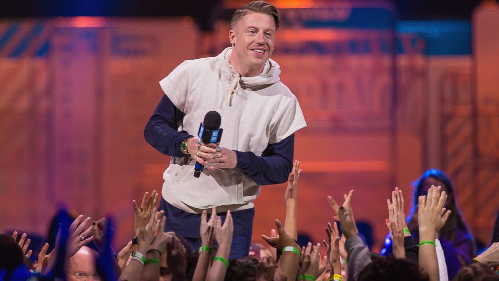 Macklemore speaks on stage during "We Day" on April 23, 2015 in Seattle.