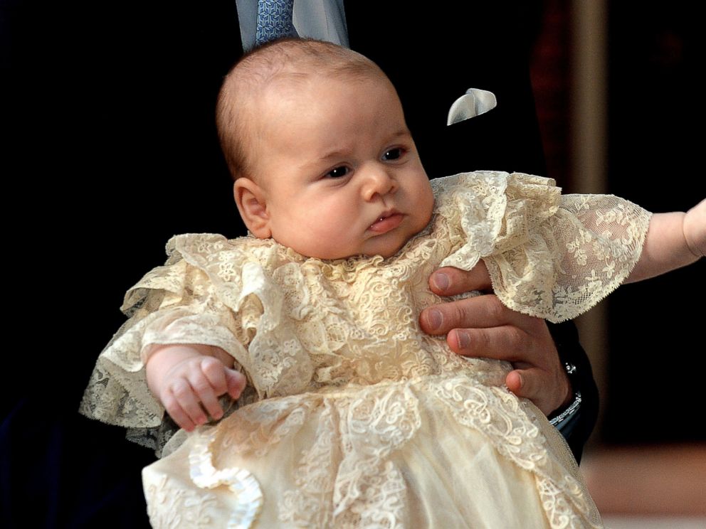 PHOTO: Britains Prince William, Duke of Cambridge holds his son, Prince George of Cambridge, as he arrives at Chapel Royal in St Jamess Palace in central London for the christening of the three month-old baby on October 23, 2013.