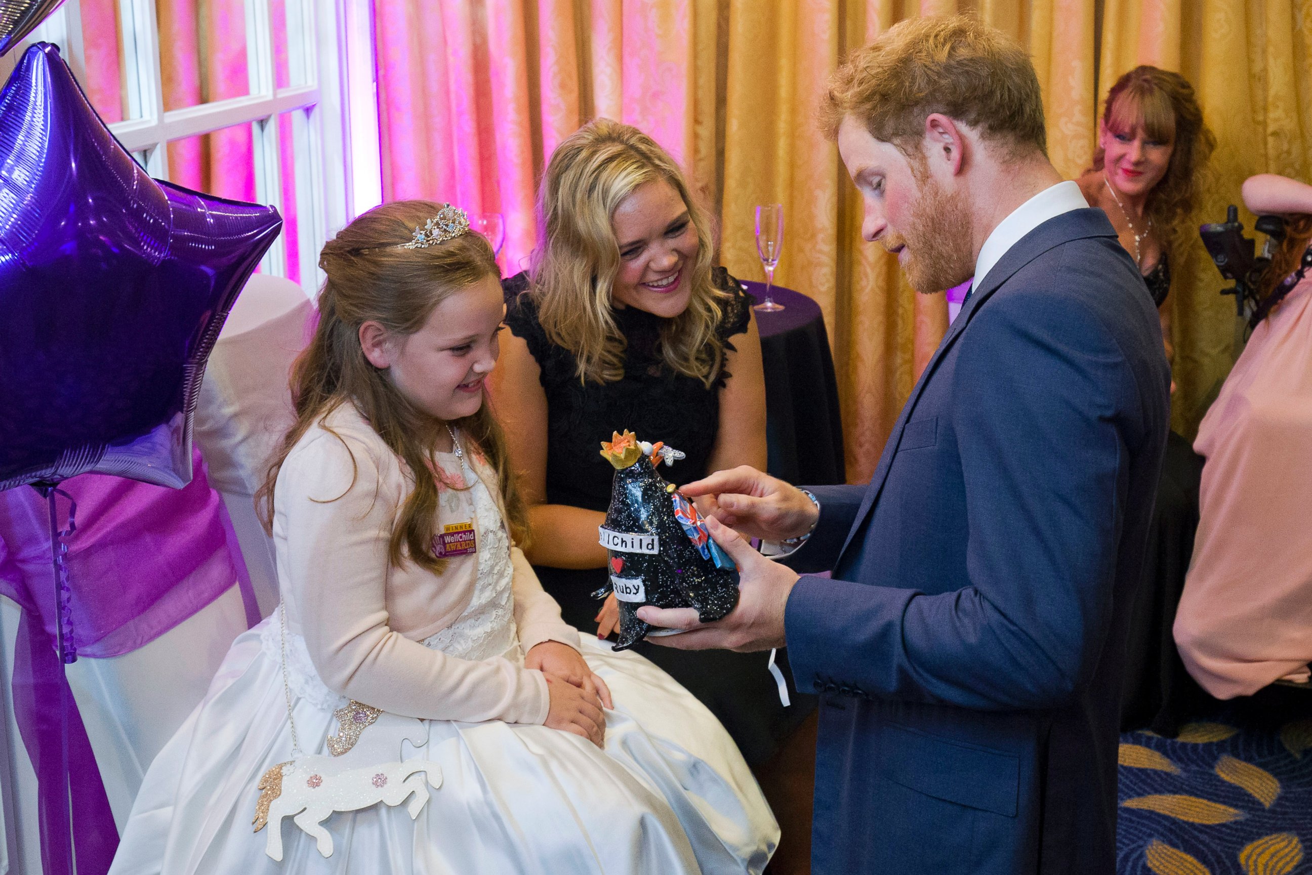 PHOTO: Prince Harry receives a gift from Ruby Smallman, 7, during an event for seriously ill children at the London Hilton, Oct. 5, 2015 in London, England.