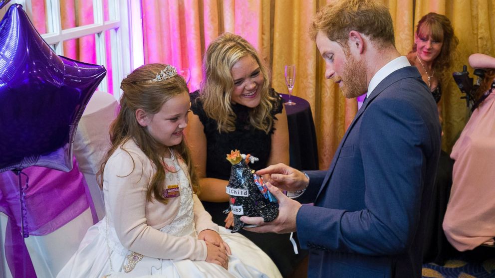 PHOTO: Prince Harry receives a gift from Ruby Smallman, 7, during an event for seriously ill children at the London Hilton, Oct. 5, 2015 in London, England.