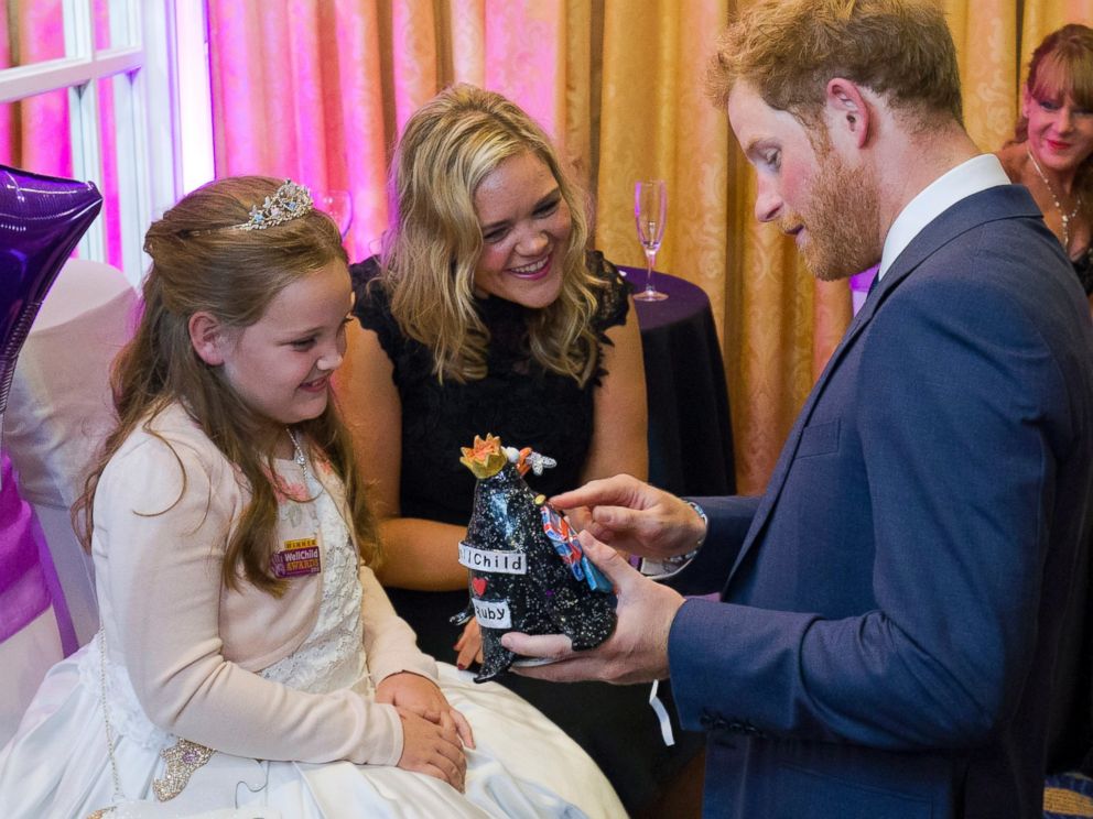 PHOTO: Prince Harry receives a gift from Ruby Smallman, 7, during an event for seriously ill children at the London Hilton, Oct. 5, 2015 in London, England.