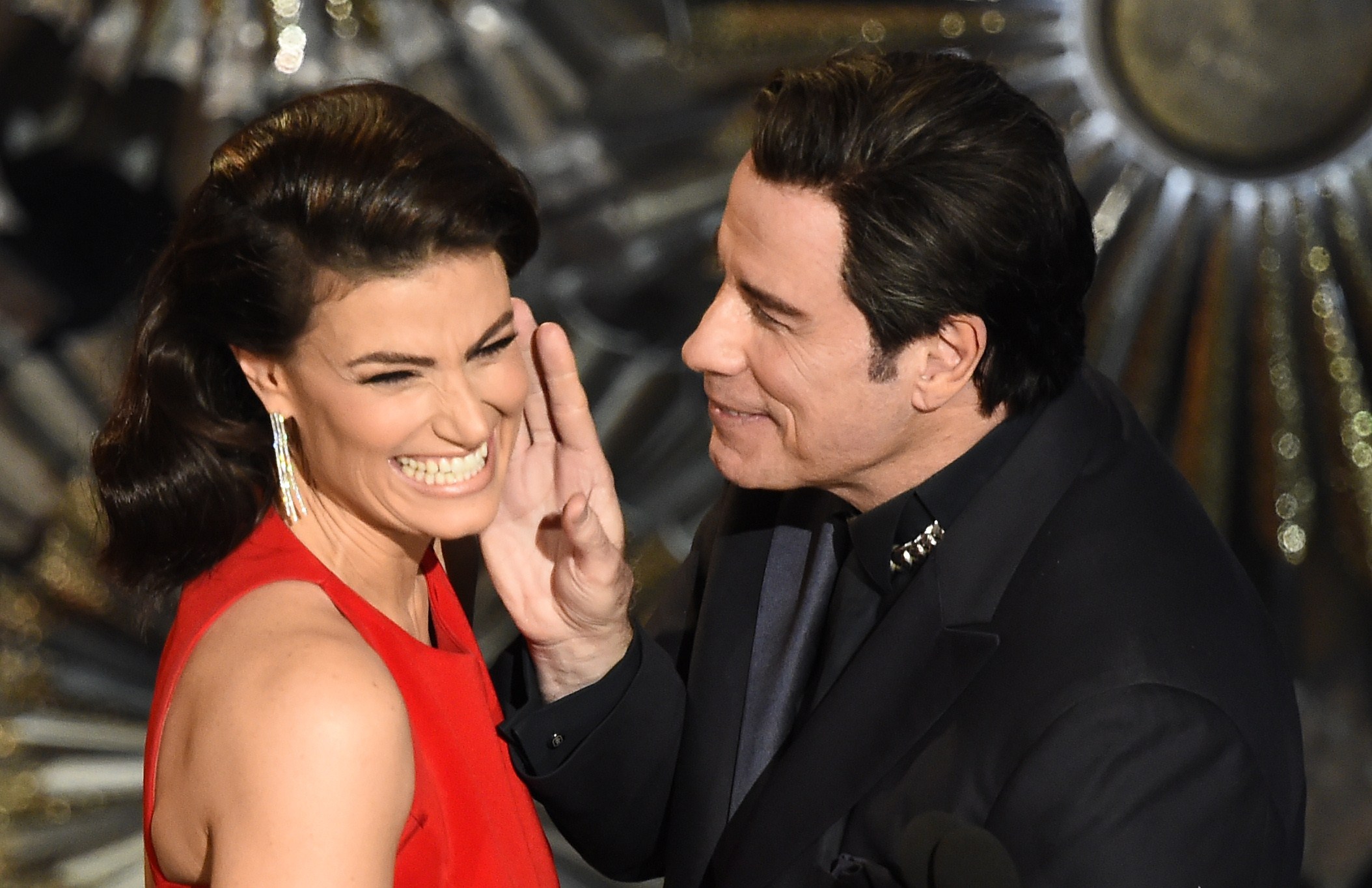 PHOTO: John Travolta (R) and Idina Menzel present an award on stage at the 87th Academy Awards, Feb. 22, 2015 in Hollywood, California. 