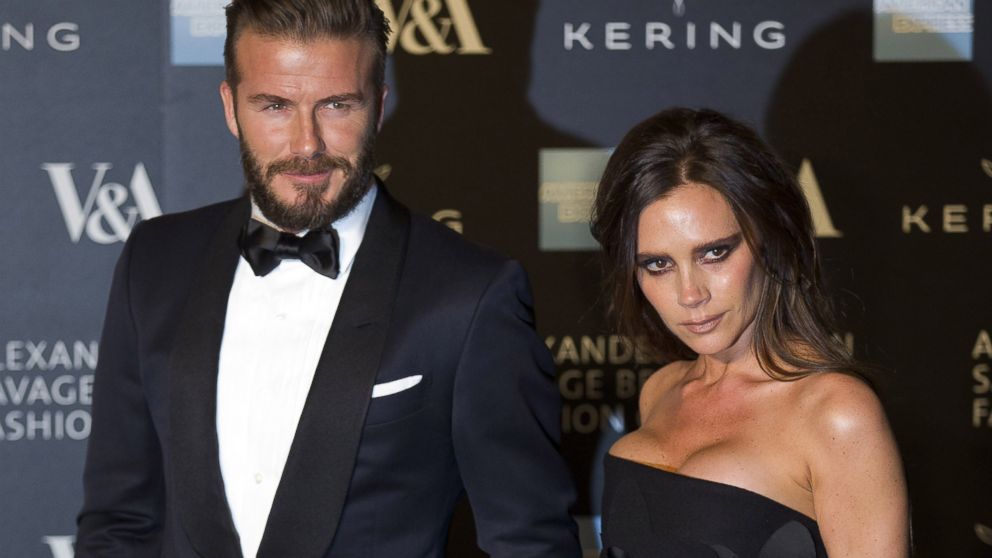 David Beckham and Victoria Beckham pose for pictures as they arrive on the red carpet for the 'Alexander McQueen: Savage Beauty Gala' at the Victorian & Albert Museum in London on March 12, 2015. 