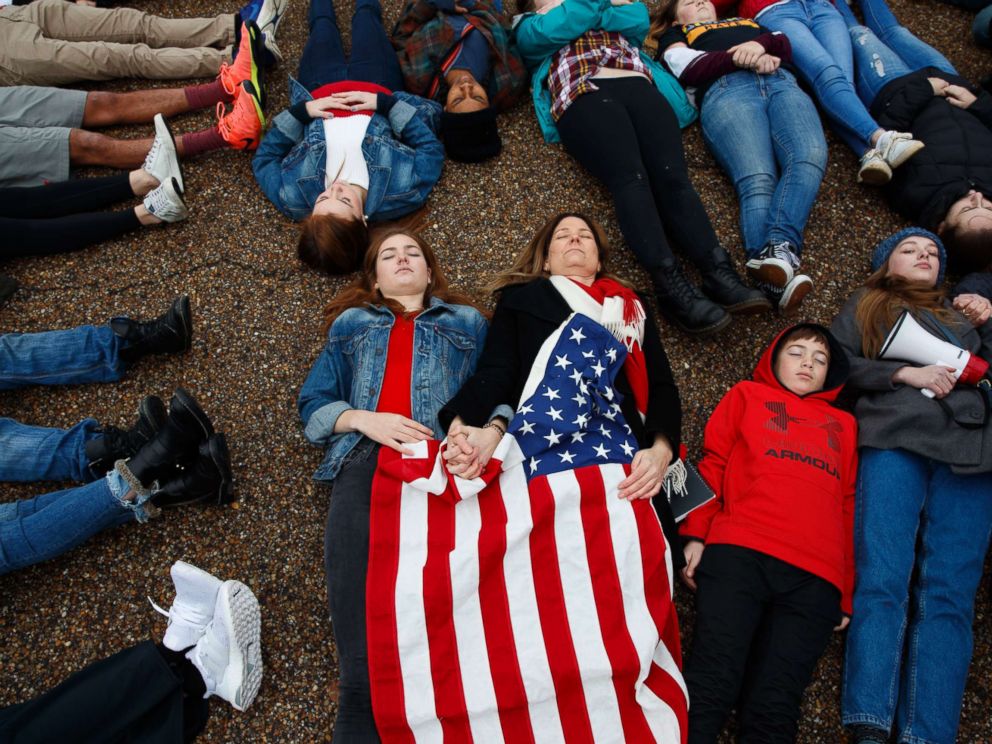 PHOTO: Abby Spangler and her daughter Eleanor Spangler Neuchterlein, 16, hold hands as they participate in a lie-in during a protest in favor of gun control reform in front of the White House, Feb. 19, 2018, in Washington.