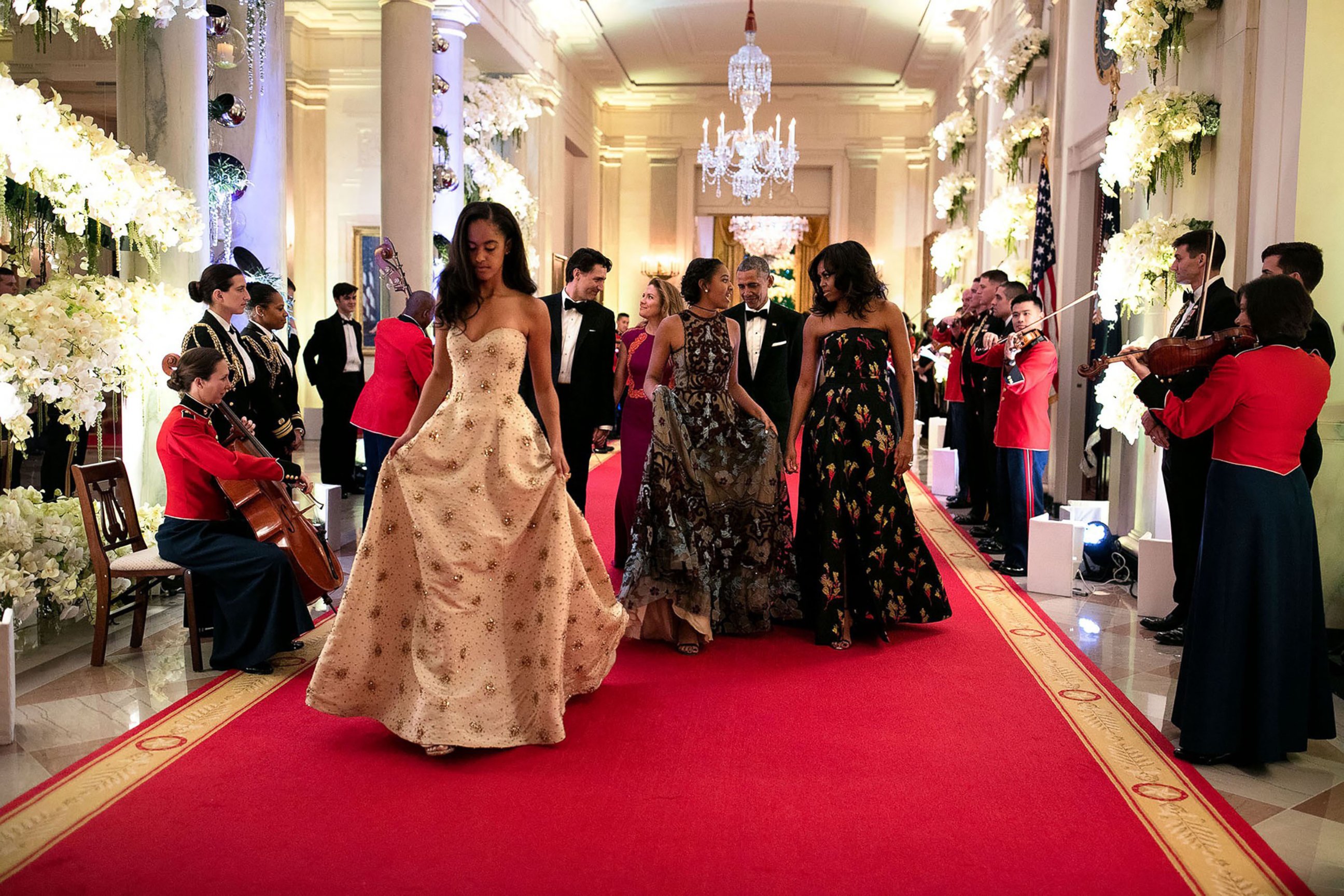 PHOTO: Malia and Sasha walk with their parents down the Great Hall in the White House as they attend their first state dinner, March 10, 2016.