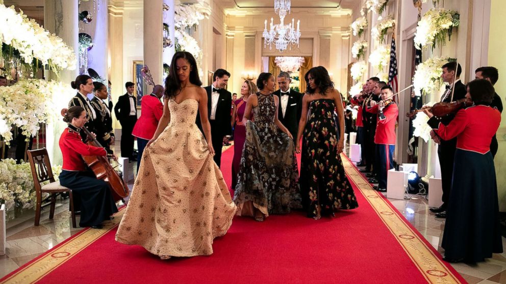PHOTO: Malia and Sasha walk with their parents down the Great Hall in the White House as they attend their first state dinner, March 10, 2016.