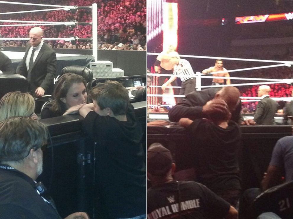 PHOTO: WWE villains Triple H and Stephanie McMahon broke character to console young fan Lucian Deering.