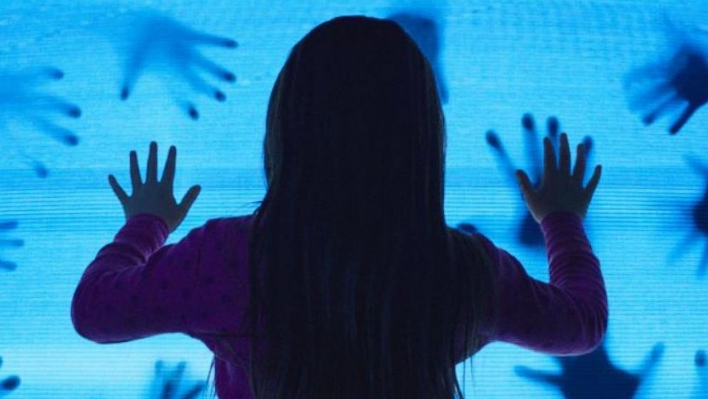 A promotional still for "Poltergeist" is pictured. 