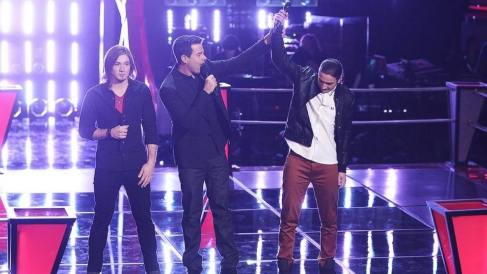 Contestants Morgan Wallen, left, and  Stevie Jo, right, are seen with host Carson Daly during an episode of 'The Voice', April 1. 2014. 