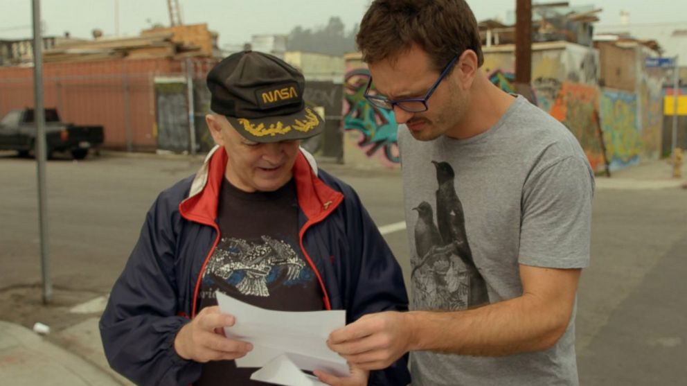 PHOTO: David Farrier, right, looks at documents in the film, "Tickled." 