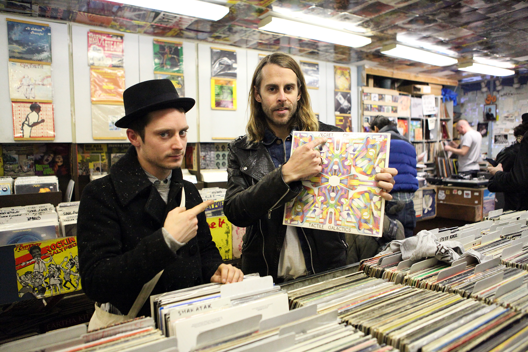 PHOTO: Elijah Wood, left, and Zach Cowie, right, present a copy of Secret Circuit's album 'Tactile Galactics' at A1 Records in New York City on Jan. 19, 2015. 