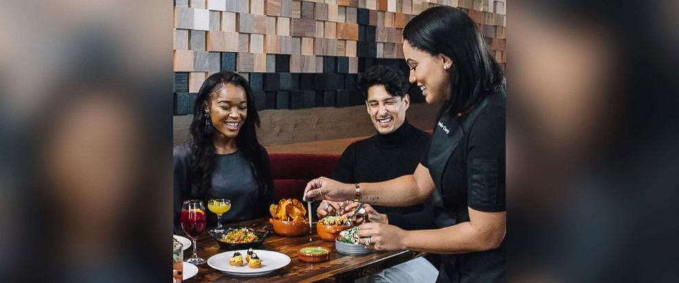 PHOTO: Ayesha Curry attends to guests at International Smoke restaurant in this photo posted on the restaurant's Instagram account. 