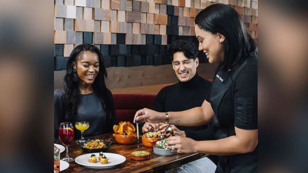 PHOTO: Ayesha Curry attends to guests at International Smoke restaurant in this photo posted on the restaurant's Instagram account. 