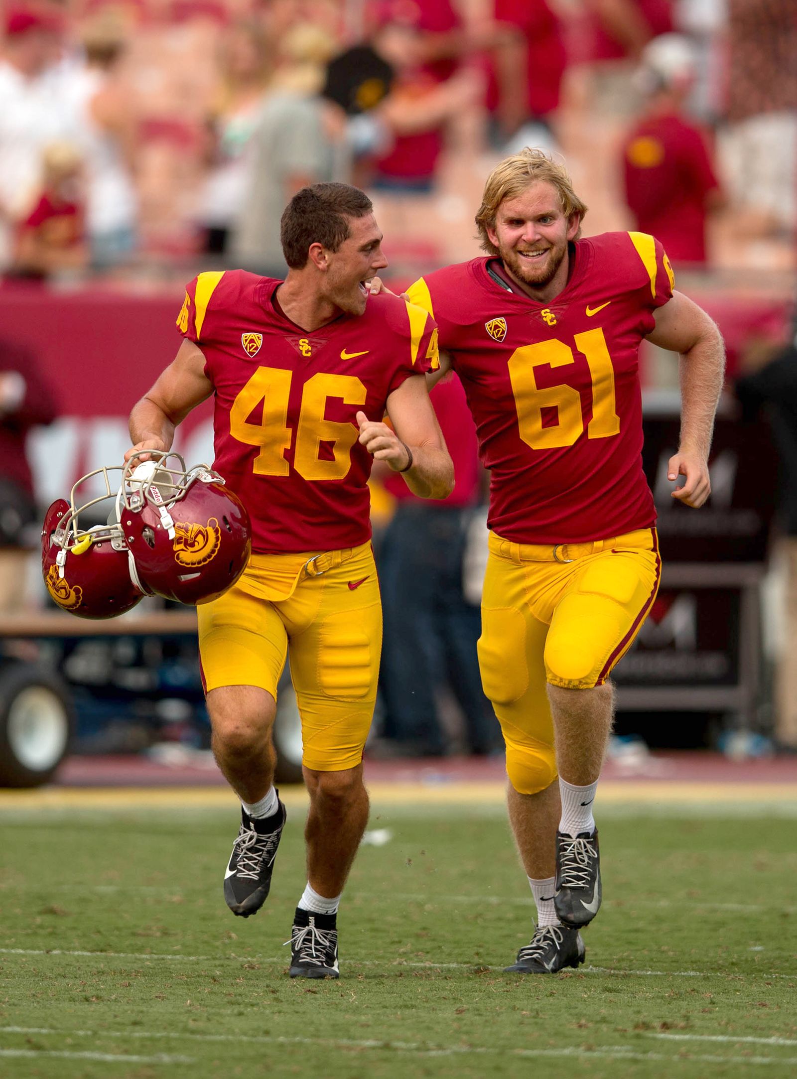 PHOTO: USC long snapper, Jake Olson, right, who has been blind since the age of 12, runs off the field with teammate Wyatt Schmidt after he snapped an extra point.