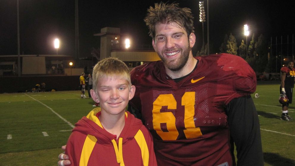 PHOTO: Jake Olson poses for a photo with former USC Trojan Kris O'Dowd in an undated family photo from a visit when Olson was a youngster.