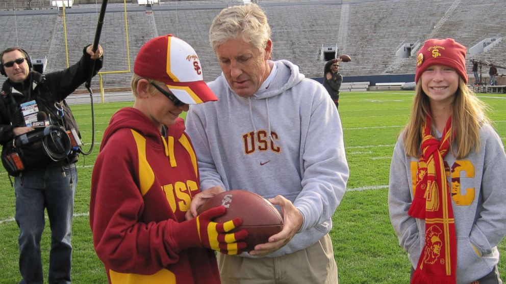 PHOTO: Jake Olson, now a long snapper for the USC Trojans, meets former USC football head coach Pete Carroll during a visit when Olson was a child.