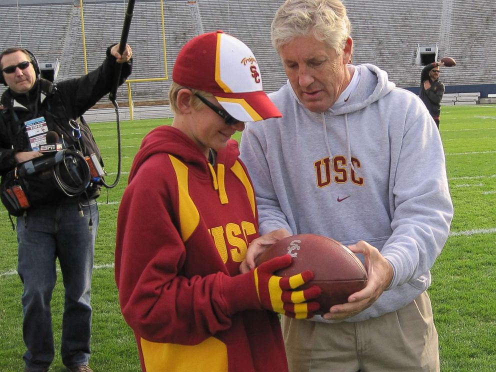 PHOTO: Jake Olson, now a long snapper for the USC Trojans, meets former USC football head coach Pete Carroll during a visit when Olson was a child.