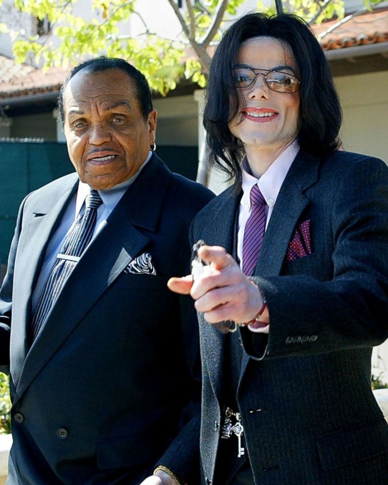 PHOTO: Singer Michael Jackson gestures as he and his father, Joseph Jackson, depart the Santa Maria Superior Court during the second week of Michael's child molestation trial March 8, 2005 in Santa Maria, Calif.