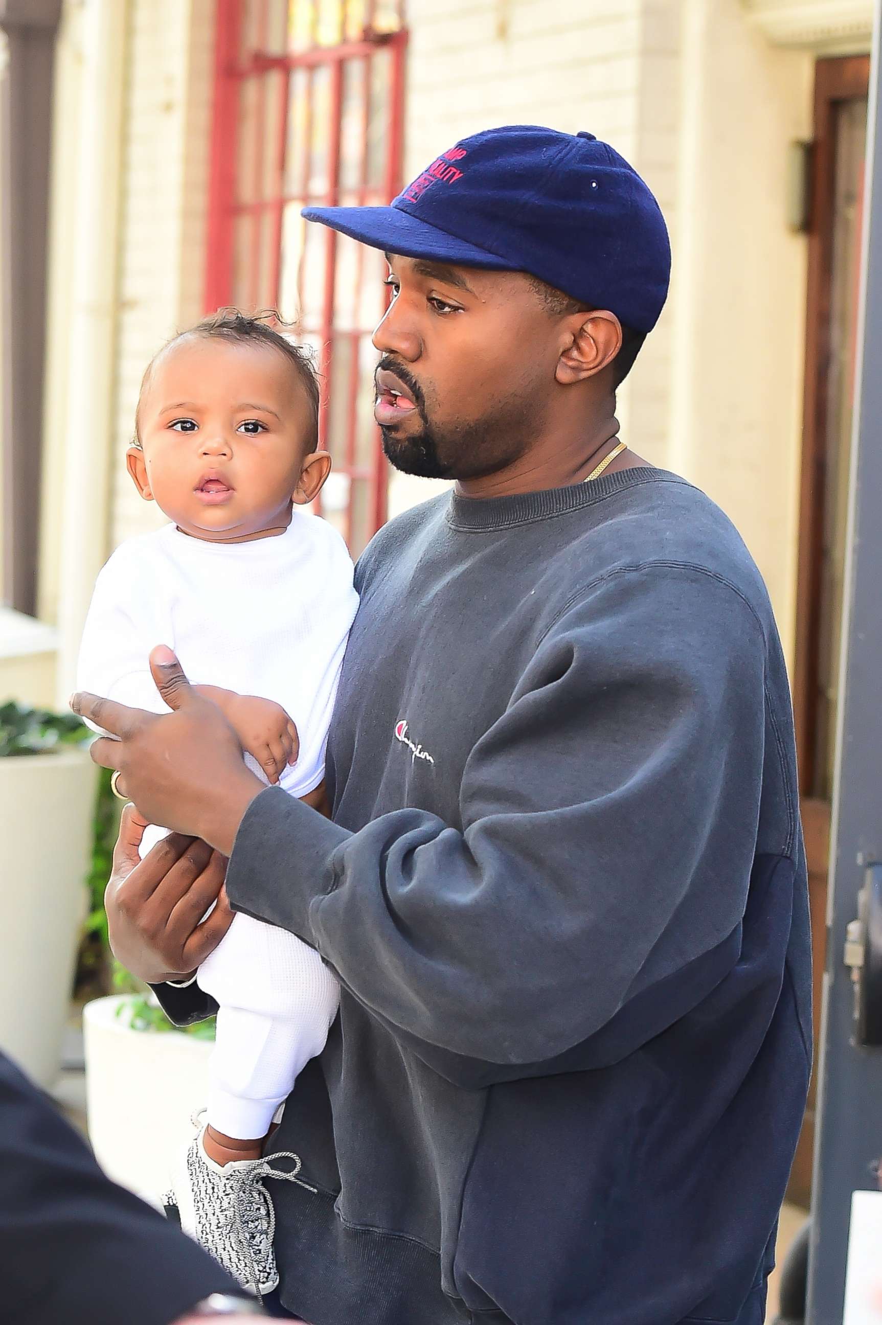 PHOTO: Kanye West holds his son Saint West on a walk in Soho in New York City on October 6, 2016.